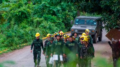 Thai soldiers walking from the cave area as operations restart on Monday